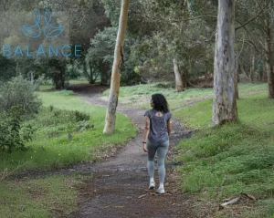 Woman walking along a forest path