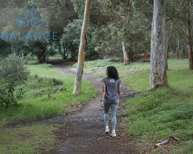 Woman walking along a forest path